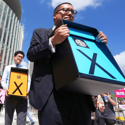 A group of activists, including members of the Progressive Lawyers Group, hold placards outside Legco. Photo: Felix Wong