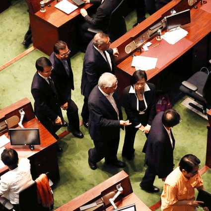 Pro-establishment lawmakers head for the exits moments before the crunch vote on electoral reform. Photo: Jonathan Wong