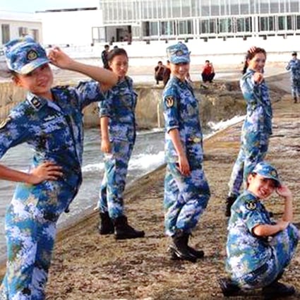Women sailors pose on a sea barrier at Fiery Cross Reef. Photo: Sina.com