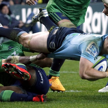Bernard Foley of the New South Wales Waratahs is tackled by Highlanders winger Waisake Naholo during their Super Rugby semi-final match in Sydney on Saturday. The Highlanders beat the Tahs 35-17. Photo: Reuters