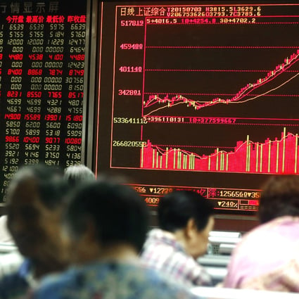 Chinese investors monitor stock prices in Shanghai, as shares opened lower on Friday in a rout from highs hit in the middle of June. Photo: EPA
