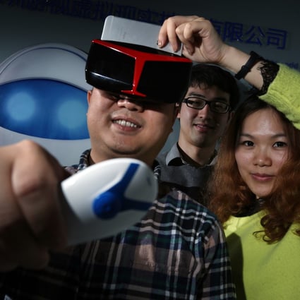 Executives from Shenzhen Game Vision Technology with the company's new motion-sensing virtual reality glasses. Shenzhen is leaping ahead of Hong Kong in technology development. Photo: Nora Tam