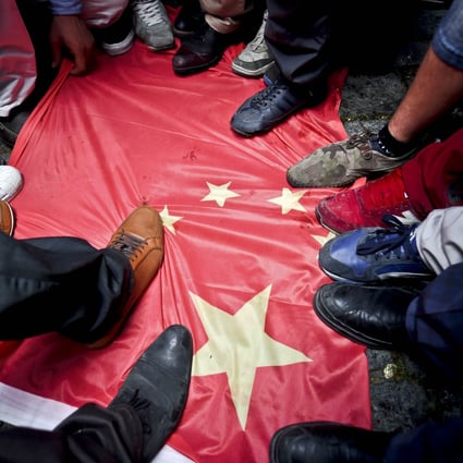 Protesters step on a Chinese flag during a protest to denounce China's treatment of ethnic Uighur Muslims, in front of the Chinese consulate in Istanbul. Photo: AFP