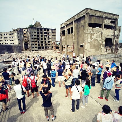Tourists visit a part of Hashima Island, commonly known as Gunkanjima, off Nagasaki in southern Japan. The island was one of 23 old industrial facilities seeking Unesco's recognition as a world heritage site. Photo: AP