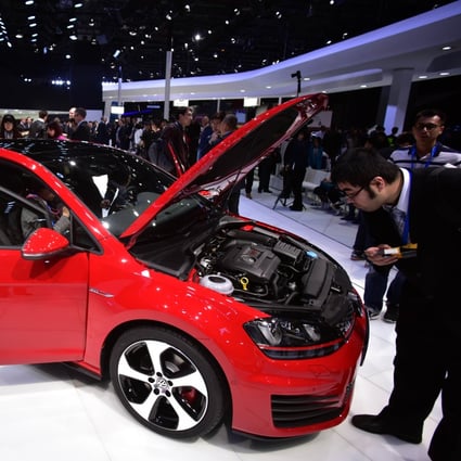 Visitors check out a car on display at an auto show in Shanghai. Photo: AFP