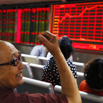 An investor smiles at a brokerage in Beijing. Photo: EPA