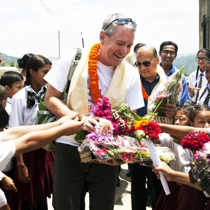 Students welcome John Wood to Shree Bagrayoginee Secondary School in Sankhu. All but three of participants there in Room to Read's girls' literacy programme lost their homes in the recent earthquakes but all have returned to school. Photo: Rishi Amatya/Room to Read