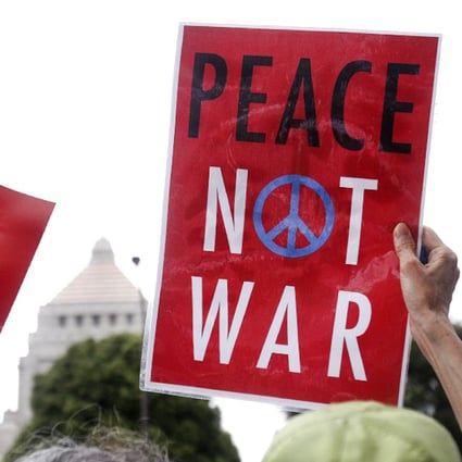 Protesters holding anti-war placards rally in front of the Parliament building in Tokyo to protest against the legislation that would expand the role of the nation's military. Photo: AP