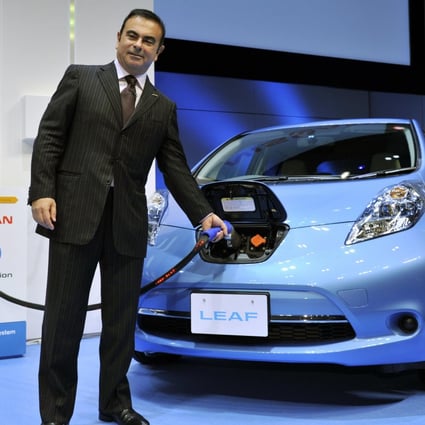 Carlos Ghosn with a Nissan Leaf electric car. Photo: AFP