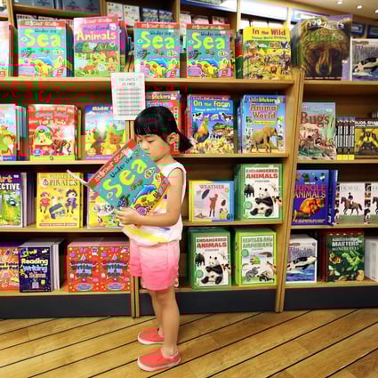 A child with an appropriate book for the fair. Photo: Nora Tam