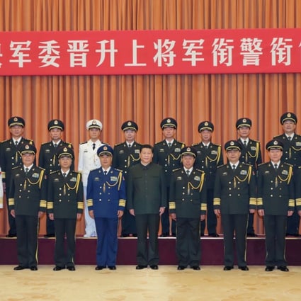 Chinese President Xi Jinping with the ten newly promoted generals at Friday's ceremony, a day after the announcement of former army chief Gen. Guo Boxiong to face prosecution for graft allegation. Photo: Xinhua 