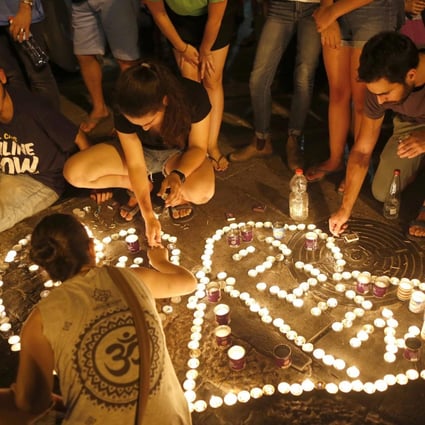 Israelis light candles after a teenager was killed.Photo: EPA