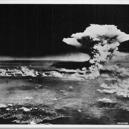 An atomic cloud billows above Hiroshima after the explosion.
