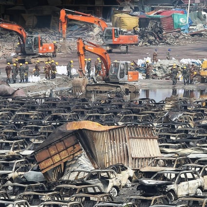 Thousands of wrecked cars and containers litter the blast site in Tianjin, where officials are involved in a desperate search for spilled sodium cyanide. Photo: KY Cheng