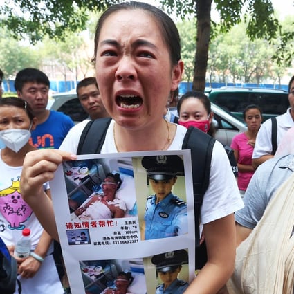Family members of the contract firefighters who perished, are missing or were injured in massive warehouse explosions, demonstrate in Tianjin. Photo: K. Y. Cheng