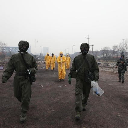 A team of specialists decked in protective gear and breathing masks enter the core of the explosion site in the port city of Tianjin on Wednesday to conduct investigations and clean up the scene. Photo: Xinhua 