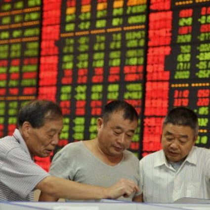 Investors in Fuyang, Anhui province, check how their stocks fared on Friday. Photo: Reuters