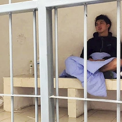 Anthony Kwan sits in a cell, after he was detained on Sunday at Suvarnabhumi Airport in Bangkok. Photo: AP
