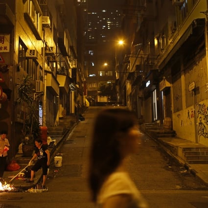 Two women burning hell money during the Hungry Ghost Festival in Hong Kong. Photo: Vincent Yu