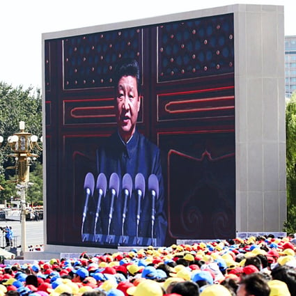 Spectators look on as an electronic screen shows President Xi Jinping delivering a speech at the start of the military parade marking the 70th anniversary of the end of the second world war. Photo: Reuters