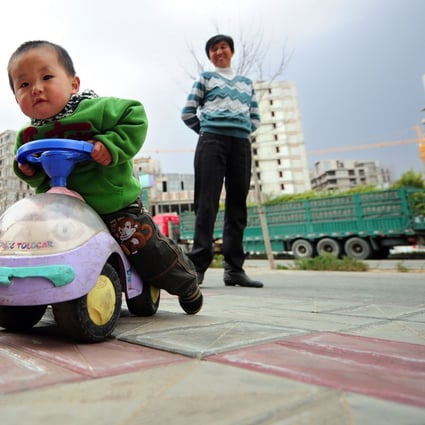 A child plays on a street in China's Inner Mongolia as developer Xinming China, which just went public in Hong Kong in July, is aiming to build itself into the first children-oriented company listed in the city. Photo: AFP