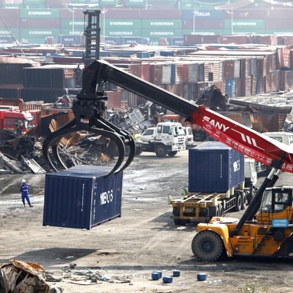 A crane moves away a destroyed container at the core area of an warehouse explosion in Tianjin, north China. Photo: Xinhua