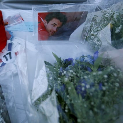 A photo of  Jules Bianchi  and flowers at a stand especially set up beside the track at the Suzuka circuit. Photo: Reuters
