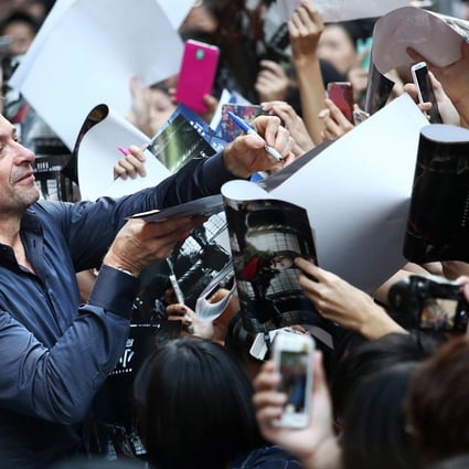 Hugh Jackman signs autographs as he greets his fans in Times Square. Photos: Jonathan Wong