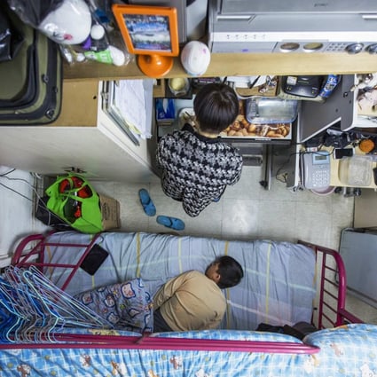 A woman and her son in a subdivided flat. About 1.34 million Hong Kong people live below the poverty line.Photo: Reuters