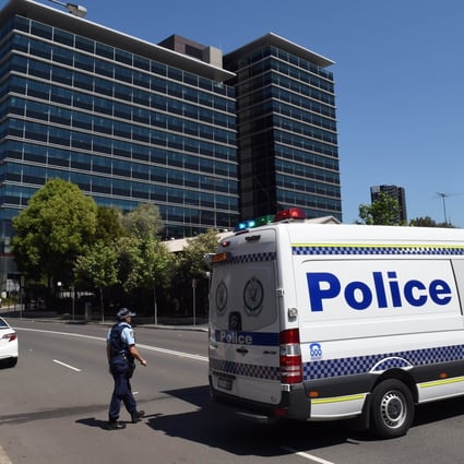 Police block off the scene near New South Wales Police Headquarters where a 15-year-old gunman shot dead a civilian police employee in Sydney. Photo: AFP