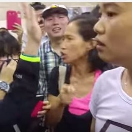 The woman (in white) during the altercation with the TVB reporter on Saturday. 