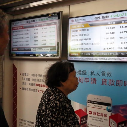 An elderly woman eyes stock prices in Hong Kong as homegrown hedge funds in China face a shake-out in the industry. Photo: Felix Wong