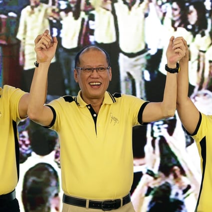 President Benigno Aquino (centre) raises the arms of his Interior Secretary Manuel ‘Mar’ Roxas and Congresswoman Maria Leonor Gerona Robredo during a political party gathering in San Juan city, eastern Manila. Photo: EPA