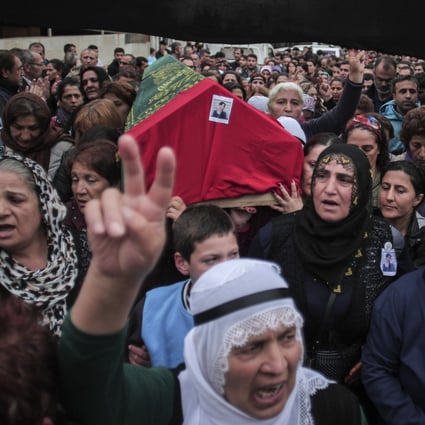 Mourners carry the coffin of Sarigul Tuylu, 35, a mother of two that was killed in Saturday's bombing attacks in Ankara. Photo: Photo: AP