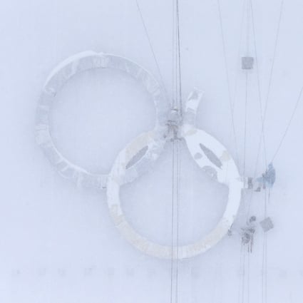 People work on the Olympic rings during heavy snow at one of the Games venues ahead of the 2014 Sochi Olympics. Photo: Reuters