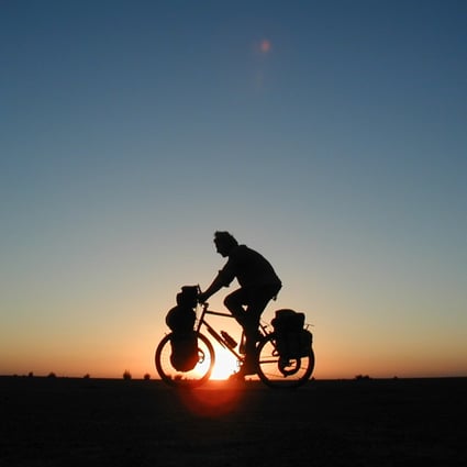 Cycling at sunset in Sudan. Photo: Alastair Humphreys