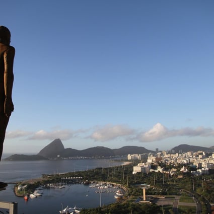 One of Antony Gormley's sculptures was displayed on the edge of a building in Rio de Janeiro, Brazil, in 2012. Photo: AP