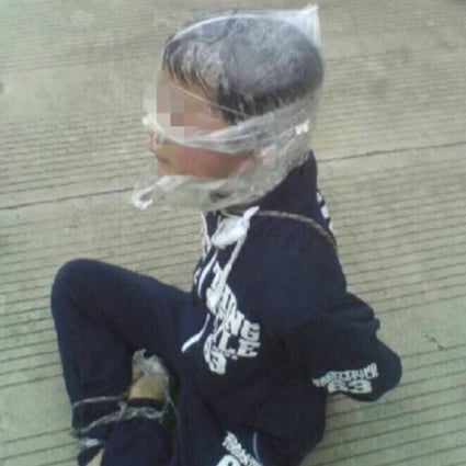 The Chinese boy, 13, who was kidnapped in Sichuan province, is photographed by a bystander after his escape. Photo:  Scol.com.cn
