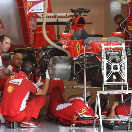 Pit crew work on Sebastian Vettel's Ferrari at the Circuit of the Americas. Photo: AFP
