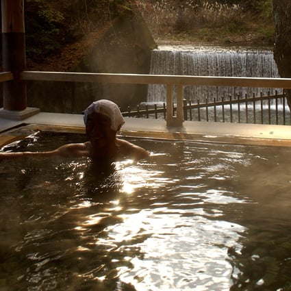 A visitor relaxes in a Japanese hot spring in Guma Prefecture. Photo: Bloomberg