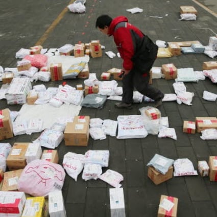 A JD.com employee sorts out parcels at a university in Beijing on Singles Day last week. Photo: EPA