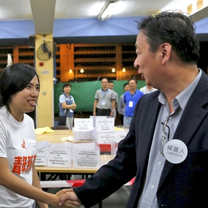 Kwong Po-Yin (left), member of ‘Umbrella soldier’ group Youngspiration, shakes hands with district council election candidate Lau Wai-Wing (right), after Kwong won a district council election at Whampoa West in Hong Kong. Reuters