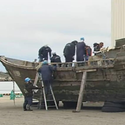 Japanese officials inspect a North Korean fishing boat.