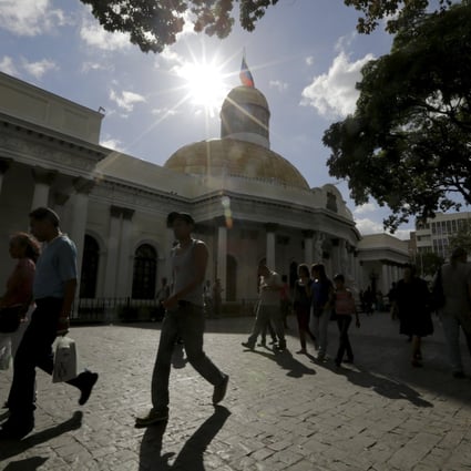 People walk past the National Assembly building in Caracas. Venezuela is the riskiest destination for Chinese to invest, according to a study by a Chinese government think tank. Photo: Reuters