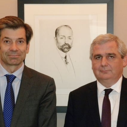 (From left) Tom van Lambaart, chief operating officer, and Stéphane Marnier Lapostolle, supply chain director, stand in front of a portrait of Grand Marnier's creator, Louis-Alexandre Marnier Lapostolle.