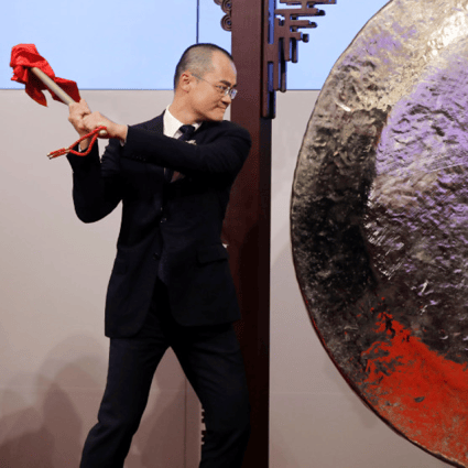 Wang hitting the Chinese gong at the Hong Kong Stock Exchange. (Picture: Reuters)
