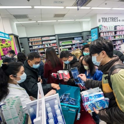 People wait in line to purchase protective masks at a store in Hong Kong on January 29. (Picture: Paul Yeung/Bloomberg)