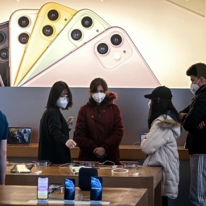 Staff and customers wearing face masks at an Apple Store in Beijing on February 22. (Picture: AFP)