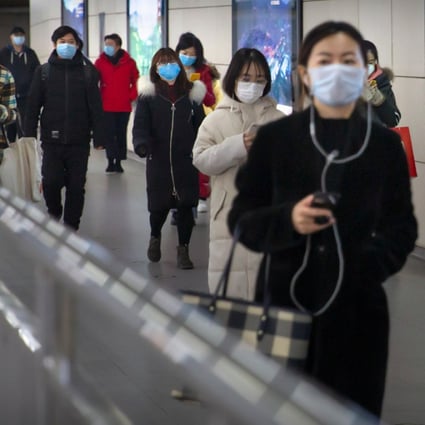 Passengers with face masks on in a Beijing subway station on March 6. (Picture: AP)