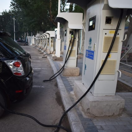 An electric car plugs in at a charging station in Beijing on September 11, 2017. (Picture: Greg Baker/AFP)
